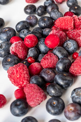wildberies, raspberries and blackberries on black plate