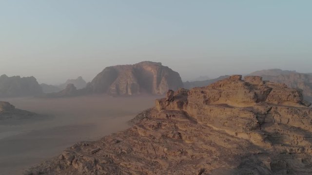Aerial drone above Wadi Rum desert at Petra, Aqaba ancient city in southern Jordan. Also known as The Valley of the Moon, fantazy and majestic formations rocks at sandy arabian desert