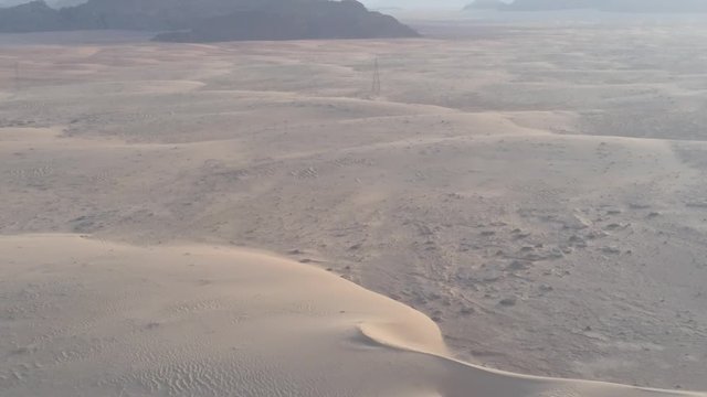 Drone shot at fantazy and majestic formations rocks with red sandy sand arabian desert. Wadi Rum desert at Petra ancient city in southern Jordan