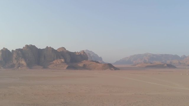 Aerial drone above Aqaba, Wadi Rum desert at Petra ancient city in southern Jordan. Also known as The Valley of the Moon, fantazy and majestic formations rocks at sandy arabian desert