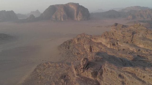 Aerial drone above Wadi Rum desert at Petra ancient city in southern Jordan. Also known as The Valley of the Moon, fantazy and majestic formations rocks at sandy arabian desert