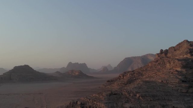 Aerial drone above Wadi Rum desert at Petra ancient city in southern Jordan. Also known as The Valley of the Moon, fantazy and majestic formations rocks at sandy arabian desert