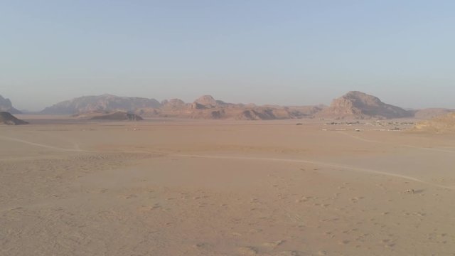 Aerial drone above Wadi Rum desert at Petra, Aqaba ancient place in southern Jordan. Also known as The Valley of the Moon, fantazy and majestic formations rocks at sandy arabian desert