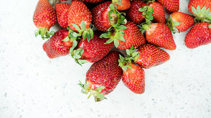 Freshly picked strawberries from the home garden. Natural organic food production. Heap of summer red berries. Homegrown, gardening and agriculture concept. Close up. Soft focus