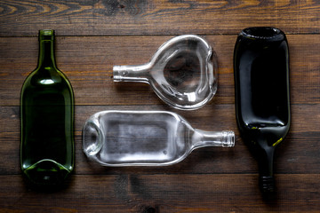 Pattern of bottles on wooden background top view