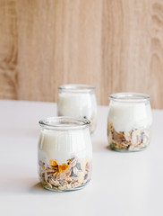 Healthy breakfast set with coffee, homemade yogurts with granola, honey or agave syrup.