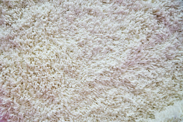 Cream material of pile texture of the carpet. Fabric for indoor decoration.