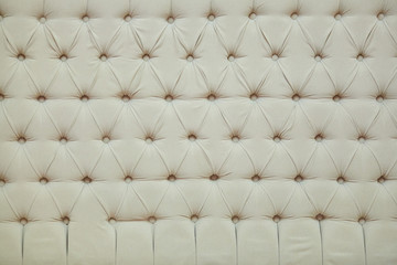 Velvet texture of the sofa background with recessed buttons.