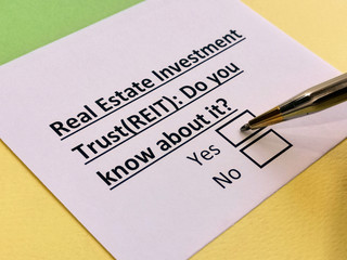 A person is answering question about real estate investment trust (REIT).