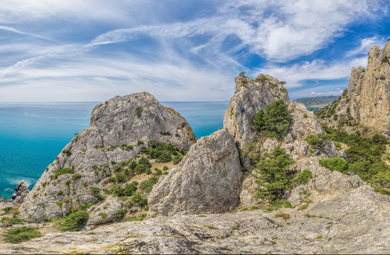 Beautiful seascape, panorama of cape Kapchik to the Galitsin Trail and blue bay of the Black Sea. Sudak, New World. Landscape of the sea coast. The concept of calmness, silence and unity with nature.