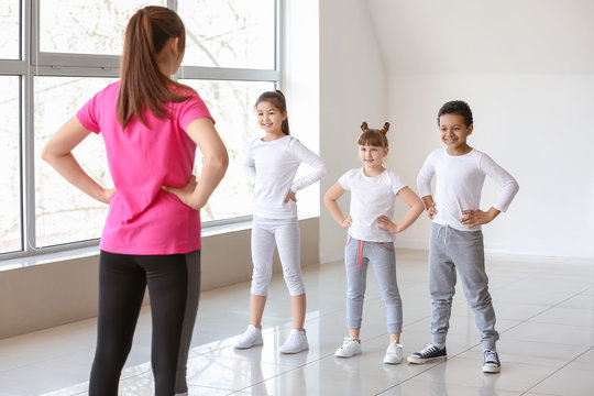 Cute little children with teacher in dance studio