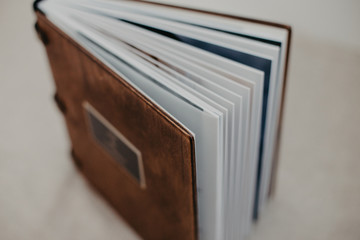 Luxury wooden photo book on linen natural background. Family memories photobook.