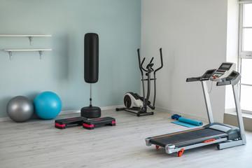Fototapeta na wymiar Interior of modern gym with exercise machines