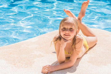 Beautiful girls at swimming pool in summer time