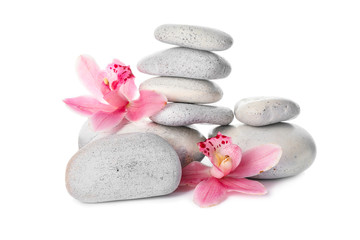 Fototapeta na wymiar Spa stones and flowers on white background