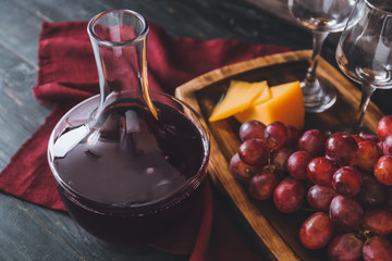 Decanter of wine with cheese on table