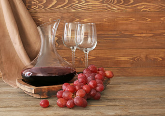 Decanter of wine with glasses on table