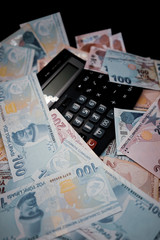 money and calculator isolated on black background.