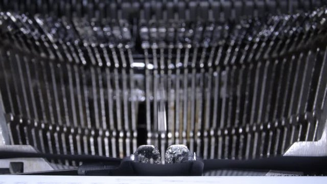 Typo keys of a qwerty typewriter hitting and writing