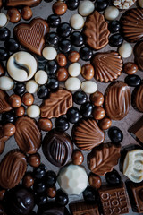 Traditional Turkish Candies designed on black surface with chocolate.Conceptual image of celebrations. Close-up chocolate. Religious Holiday, The Sugar Feast After Ramadan. Top view.
