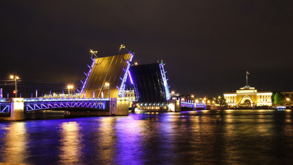Naklejka na ściany i meble Illuminated Bridge Over River At Night
