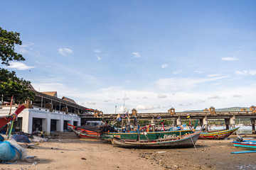 Fototapeta na wymiar Fishing boats on the shore at low tide . Thailand