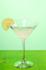 margarita cocktail in martini glass on a light green background