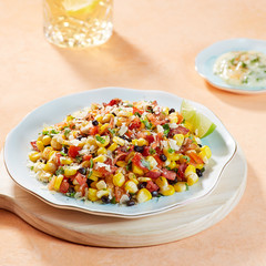 Mexican salad dish on light orange background, served with mayonnaise sauce. 
