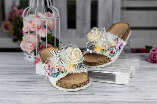 Luxury, fashionable female Slippers on rustic wooden surface