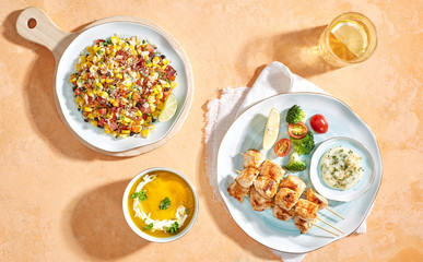Combo menu set : Mexican salad, pumpkin soup and grilled chicken skewers. Flatlay angle