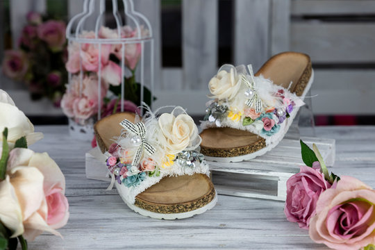 Luxury, fashionable female Slippers on rustic wooden surface