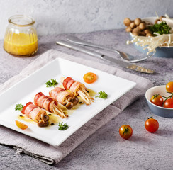 Bacon rolls mushrooms and element around the main dish