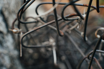 Fototapeta na wymiar Rusty iron wire. Old mesh netting. Pieces of wire. Scrap metal. Close-up. Macro