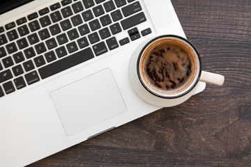 Wooden desk table with computer and hot coffee