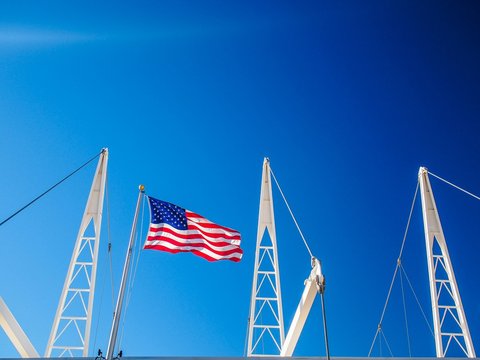 Low Angle View Of American Flag At Utah Olympic Oval Against Clear Blue Sky