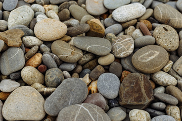 Pebble beach stones on the black sea. Close-up. Isolated. Texture of beach stones.