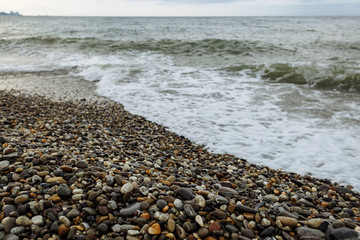 Shore of the Black Sea. In the foreground are photographs of a pebble beach and sea stretching over the horizon. Waves at sea.