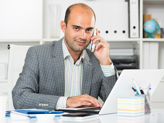 Cheerful bussinesman talking on the phone
