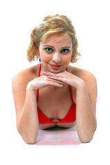 A woman in red bra top resting her chin on her hands