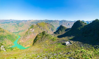 Fototapeta premium Ha Giang karst geopark mountain landscape in North Vietnam. Winding road in stunning scenery. Ha Giang motorbike loop, famous travel destination bikers easy riders.