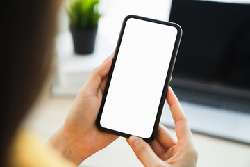 Woman hand holding smartphone and touching blank screen. Mockup of advertisement.
