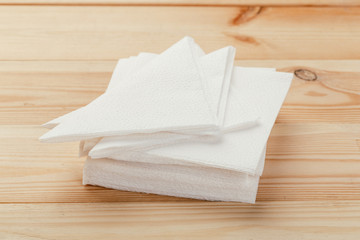 white paper napkin or tissue on the wooden table background.