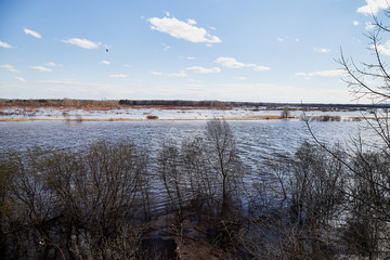 High water on a river or on a lake in sunny spring day