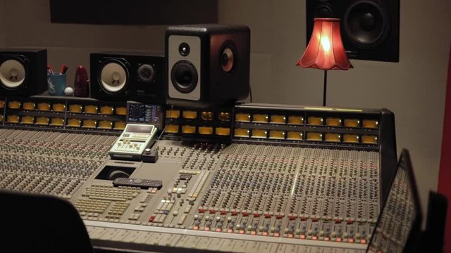 Analog Sound Mixing Console And Audio Speakers Inside A Studio - closeup shot