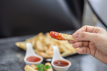 young woman eating French fries.