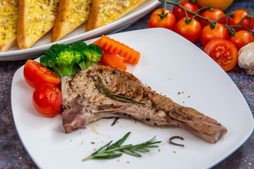 Grilled pork steak with mashed potatoes broccoli and gravy.