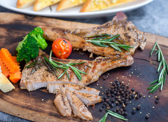 Fresh raw pork chops steak with pepper and rosemary on wooden background, home cooking, Quarantine COVID-19, soft focus, copy space.