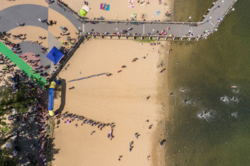 Triathlon swimming contest in lake swimmers competition aerial drone photo

