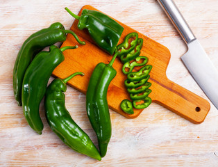 Whole and sliced green peppers
