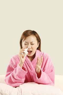 Woman Holding Tissue Paper About To Sneeze